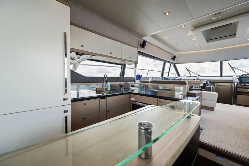 Slide: The Image of Modern kitchen interior on a 2016 Prestige 620 yacht with panoramic windows. - 25