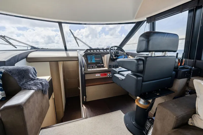 Slide: The Image of Interior helm of 2016 Prestige 620 yacht with modern controls and panoramic windows. - 27