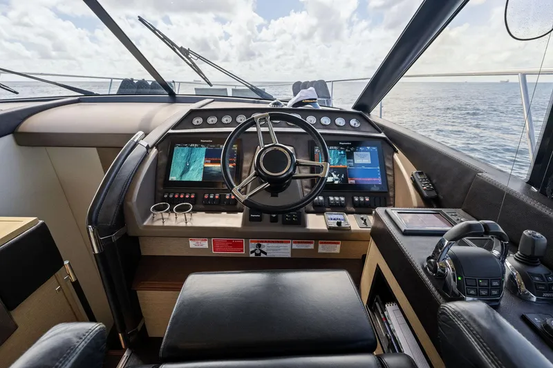 Slide: The Image of Prestige 620 yacht helm station, 2016 model, with advanced navigation controls and ocean view. - 28
