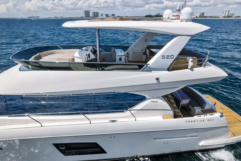Slide: The Image of 2016 Prestige 620 yacht cruising on open water. - 3