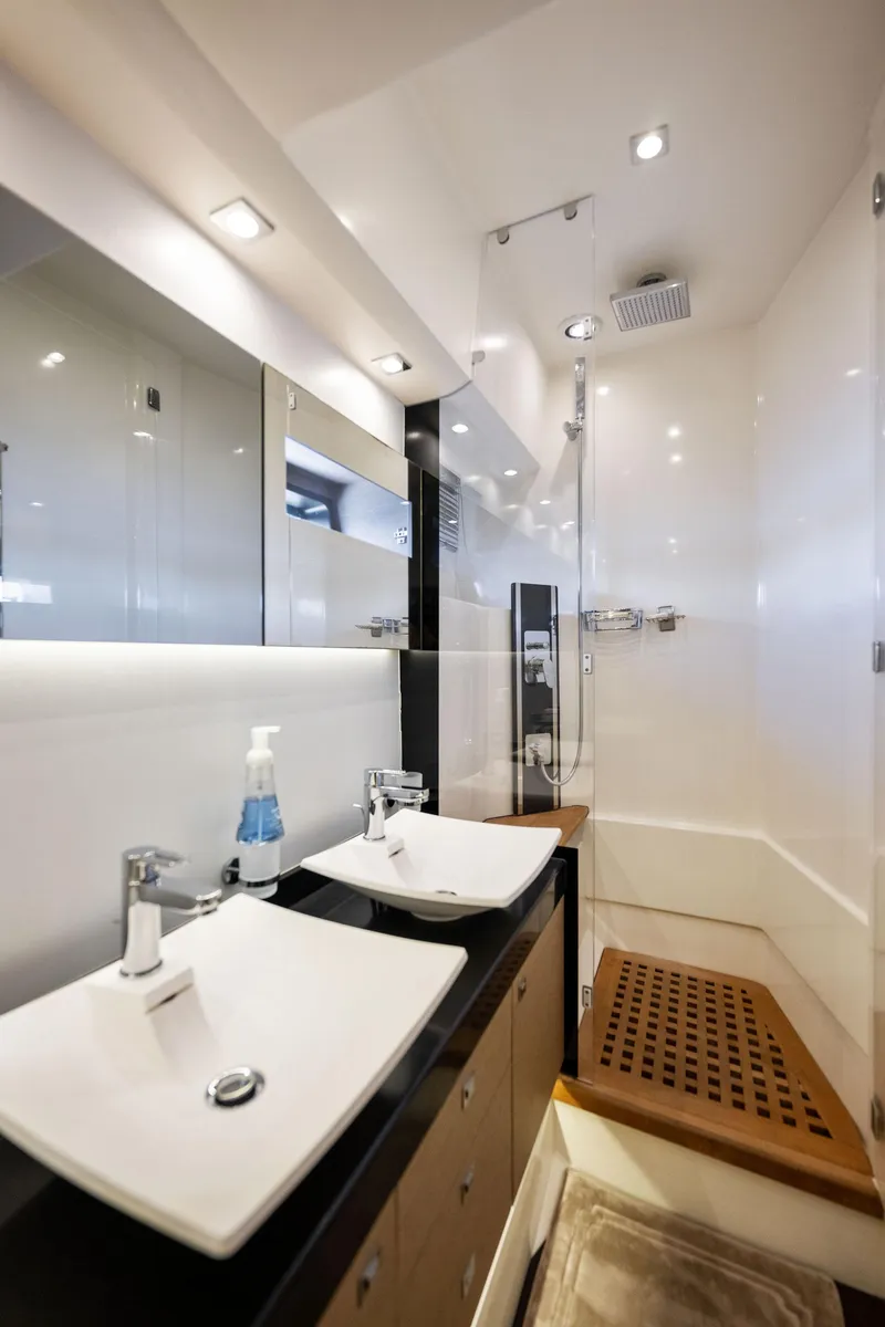 Slide: The Image of Modern bathroom in a 2016 Prestige 620 yacht with dual sinks and a shower. - 33