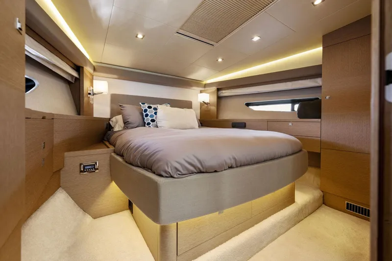 Slide: The Image of Luxurious bedroom interior of 2016 Prestige 620 yacht with modern lighting and cozy bedding. - 34