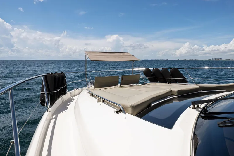 Slide: The Image of Prestige 620 yacht 2016 model cruising on open sea under clear blue sky. - 7