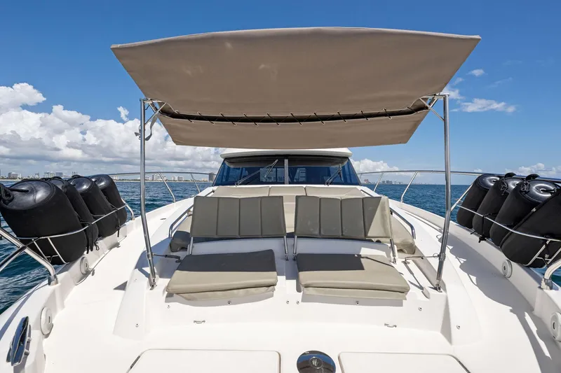 Slide: The Image of Prestige 620 yacht 2016 model with sunshade and lounge seating on deck. - 8