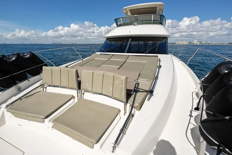 Slide: The Image of Prestige 620 yacht 2016 model with sun loungers on deck, cruising on open water. - 9