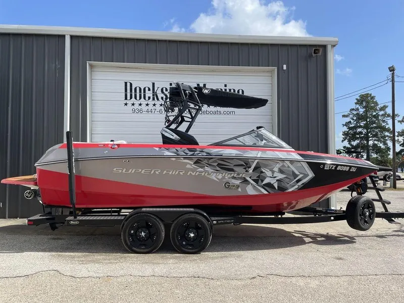 Slide: The Image of 2015 Nautique G23 Super Air wakeboard boat on trailer outside Dockside Marine. - 0
