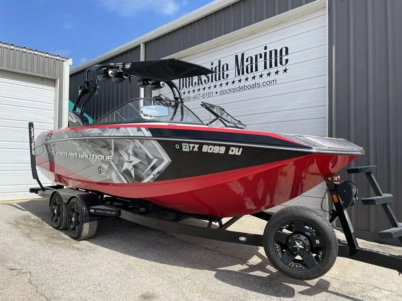 Slide: The Image of 2015 Nautique G23 Super Air boat in red and black on trailer at Dockside Marine. - 1