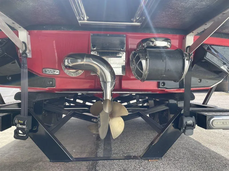 Slide: The Image of 2015 Nautique G23 boat underside showing propeller and exhaust system. - 2