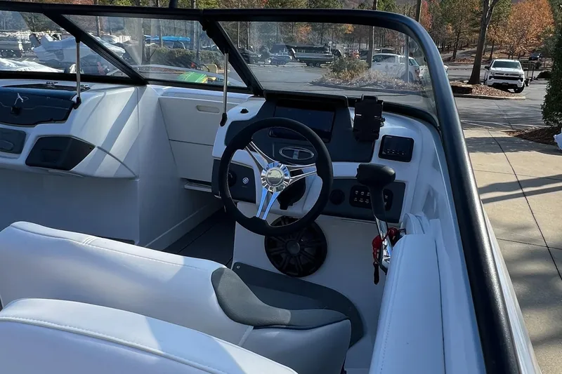 Slide: The Image of 2024 Tahoe 210 S boat interior with steering wheel and dashboard. - 3