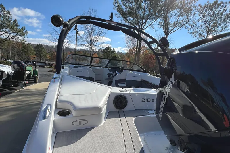 Slide: The Image of 2024 Tahoe 210 S boat with Mercury engine, docked outdoors on a sunny day. - 4