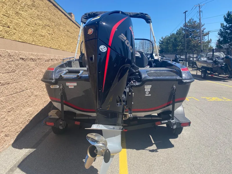 Slide: The Image of 2024 Nitro ZV19 Sport Pro boat with powerful outboard motor, parked outdoors. - 5