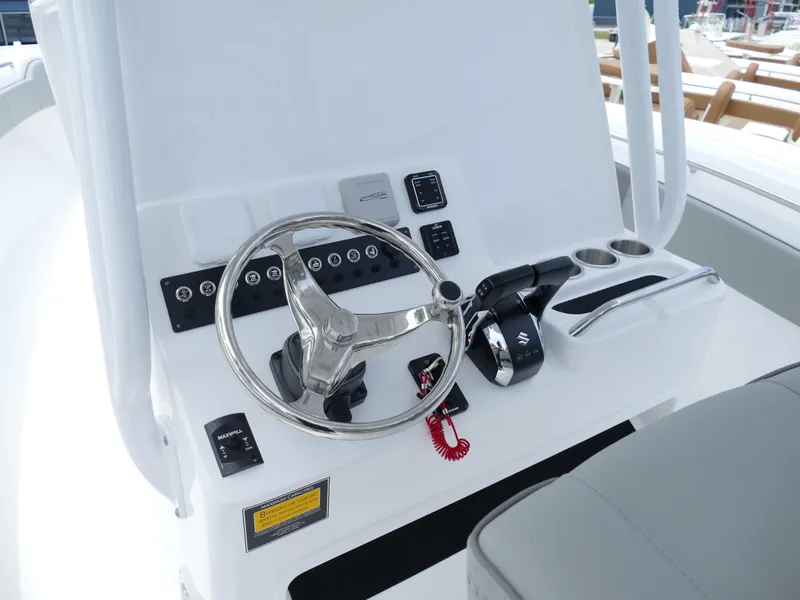 Slide: The Image of 2024 Cape Horn 31T Tournament boat helm with steering wheel and controls. - 13