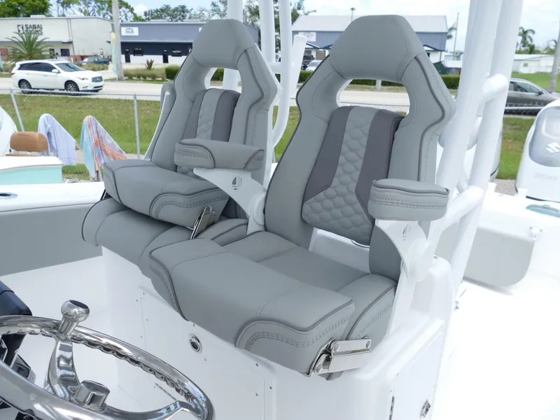 Slide: The Image of 2024 Cape Horn 31T Tournament boat with dual grey captain's chairs and steering wheel. - 21