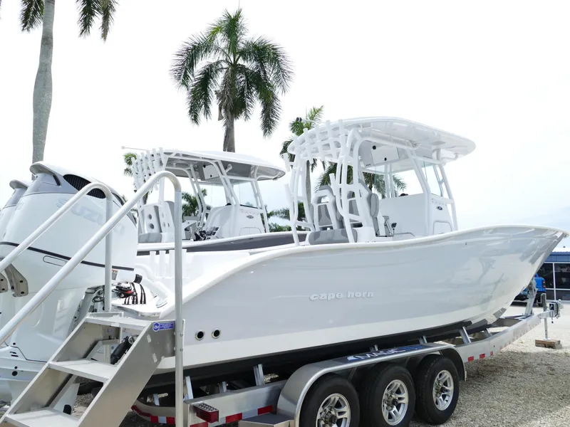 Slide: The Image of 2024 Cape Horn 31T Tournament boat on trailer with palm trees in background. - 5