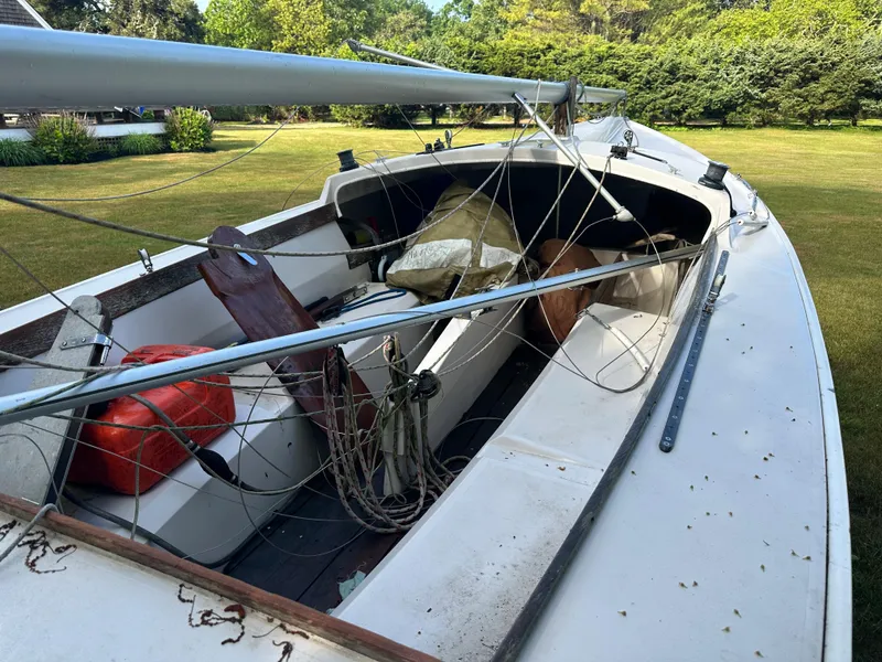 Slide: The Image of Rhodes 19 sailboat from 2000 with rigging and equipment, docked on grassy area. - 4