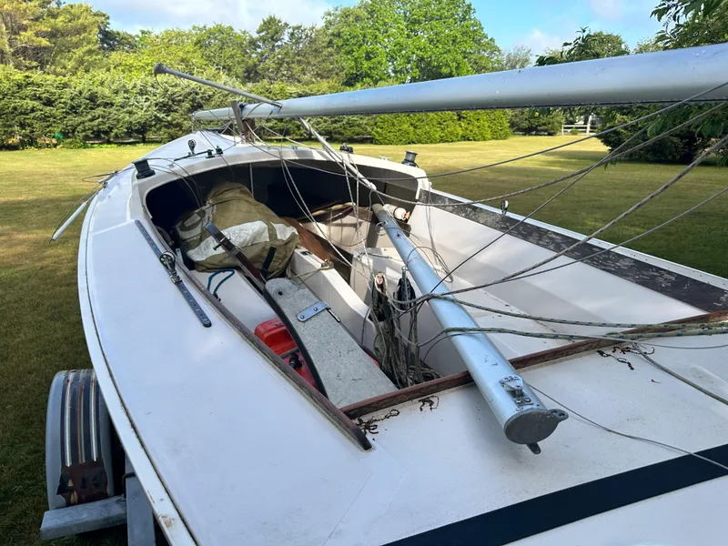 Slide: The Image of Rhodes 19 sailboat from 2000 on a trailer in a grassy yard. - 5