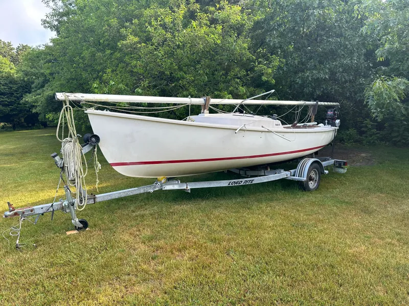 Slide: The Image of White 2000 Rhodes 19 sailboat on trailer in grassy area. - 6