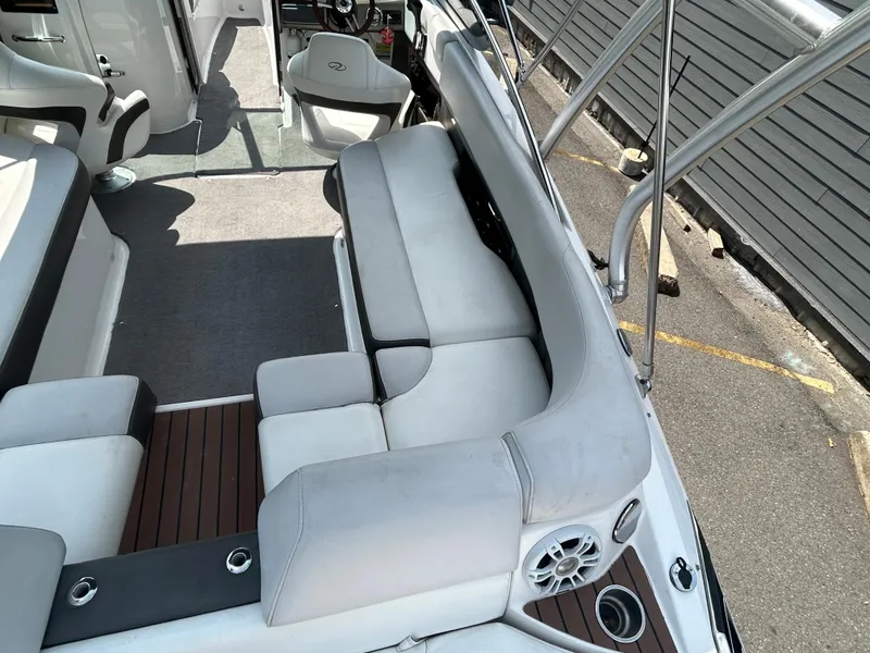 Slide: The Image of 2011 Regal 2500 Bowrider interior with white seating and wood accents. - 13