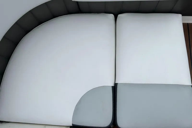 Slide: The Image of 2011 Regal 2500 Bowrider white and gray cushioned seating. - 15