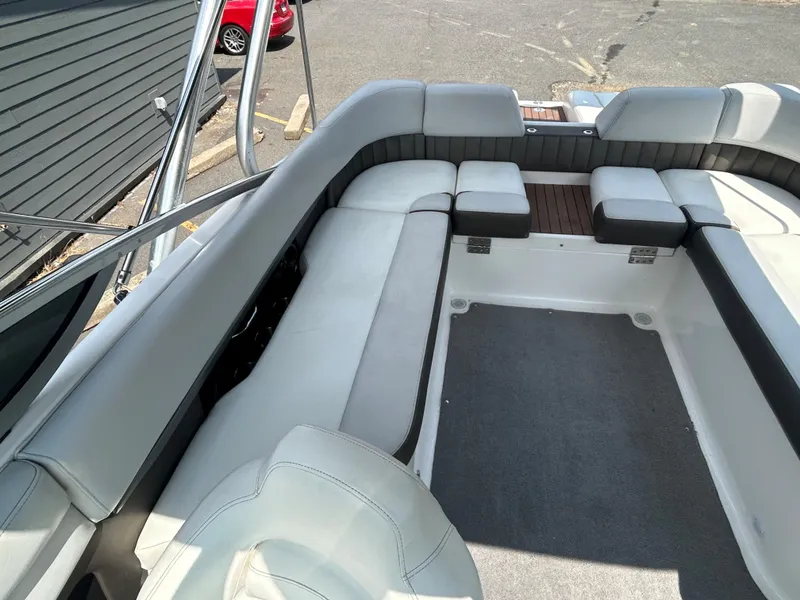 Slide: The Image of 2011 Regal 2500 Bowrider boat interior with spacious seating and grey upholstery. - 18