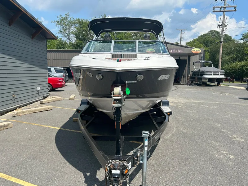 Slide: The Image of 2011 Regal 2500 Bowrider boat on trailer in parking lot. - 2