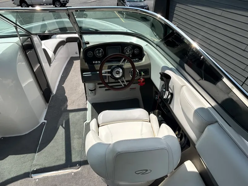 Slide: The Image of 2011 Regal 2500 Bowrider boat interior with steering wheel and seating. - 20