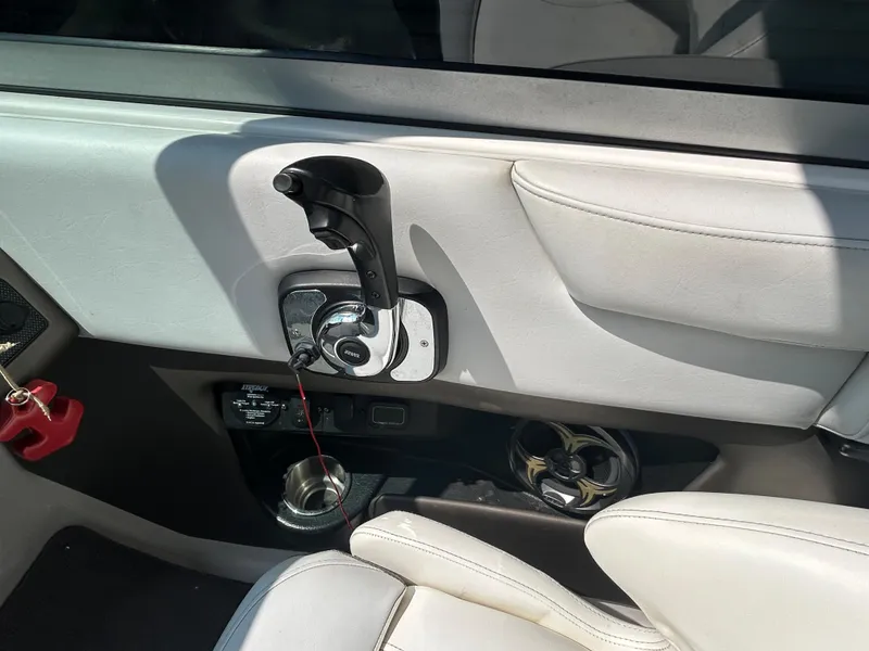 Slide: The Image of 2011 Regal 2500 Bowrider boat interior control panel and throttle. - 22