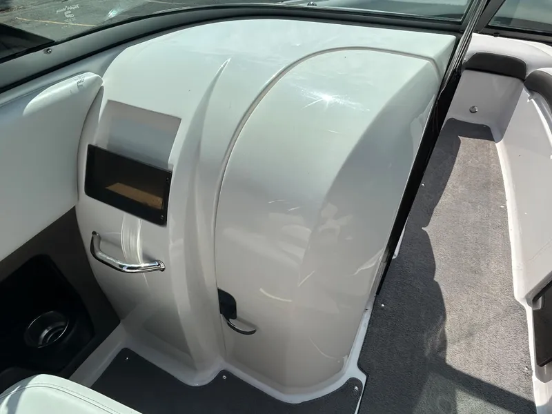 Slide: The Image of 2011 Regal 2500 Bowrider interior, featuring sleek white dashboard and seating area. - 23