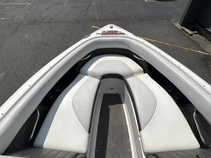 Slide: The Image of 2011 Regal 2500 Bowrider boat interior with white cushioned seating. - 25