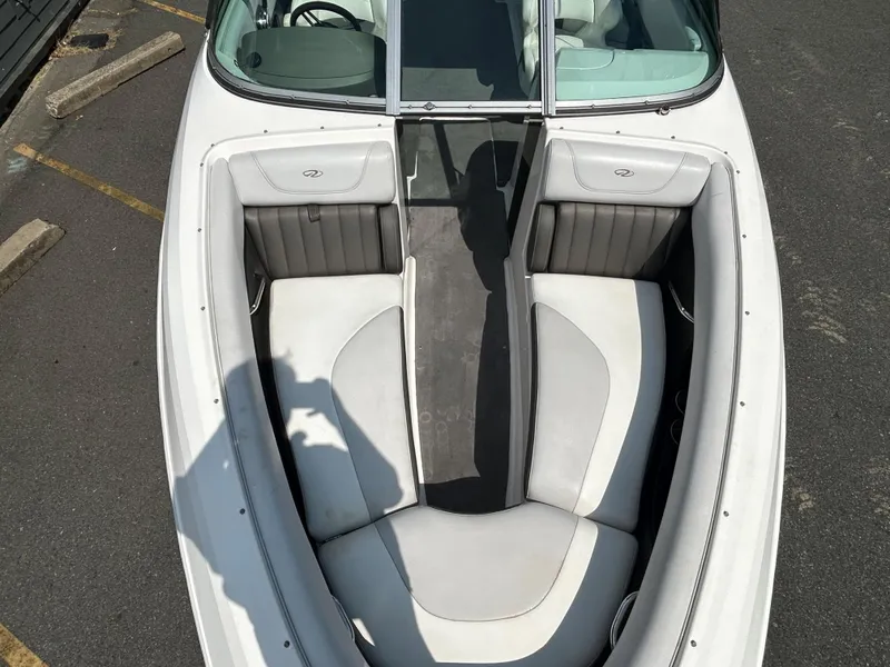Slide: The Image of 2011 Regal 2500 Bowrider boat with white and gray interior seating. - 26
