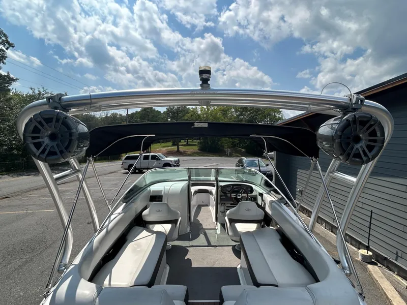 Slide: The Image of 2011 Regal 2500 Bowrider boat interior with seating and speakers under a sunny sky. - 31