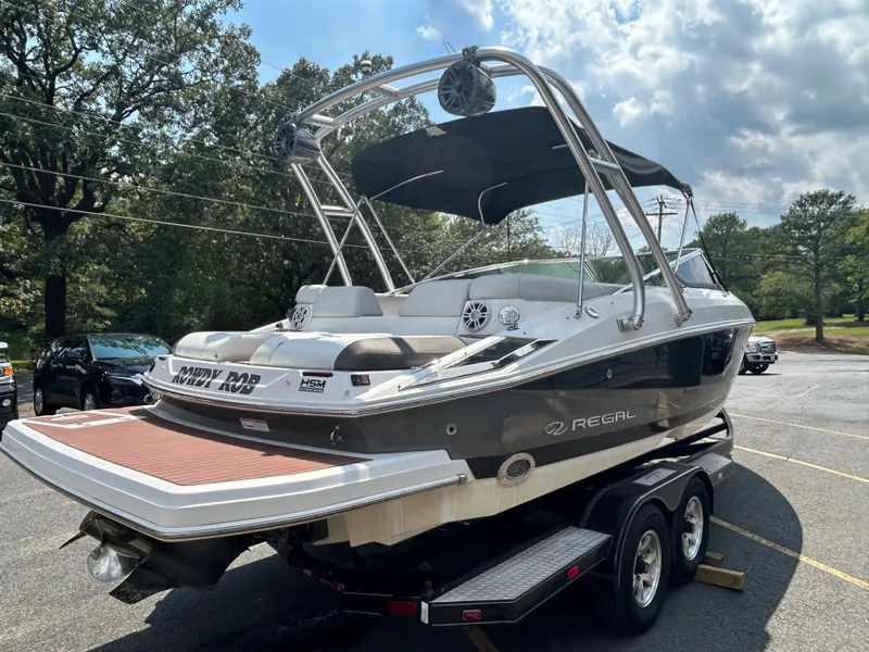 Slide: The Image of 2011 Regal 2500 Bowrider boat on a trailer in a parking lot. - 4