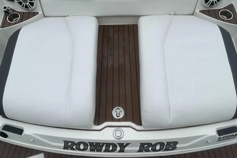 Slide: The Image of 2011 Regal 2500 Bowrider boat with white seating and teak flooring. - 9