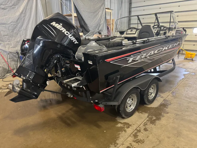 Slide: The Image of 2018 Tracker Targa V-19 WT boat with Mercury engine in a garage setting. - 3
