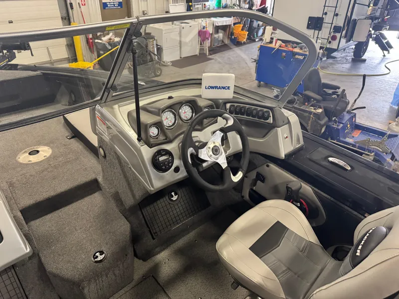 Slide: The Image of 2018 Tracker Targa V-19 WT boat interior with gray seating and carpeted floor. - 8