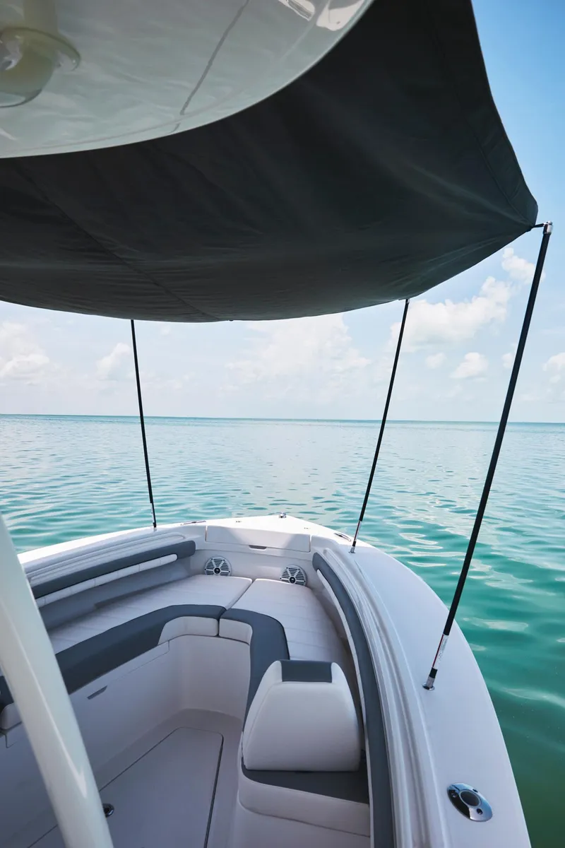 Slide: The Image of 2024 Regulator 23 boat with sunshade on calm water. - 8