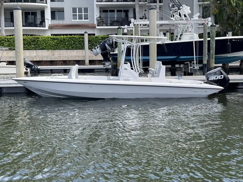 Slide: The Image of 2023 Velocity 260 Bay boat docked at a marina. - 3