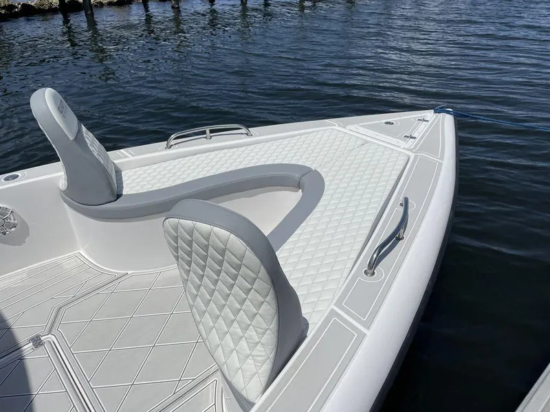 Slide: The Image of 2023 Velocity 260 Bay boat with white quilted seating on the water. - 9