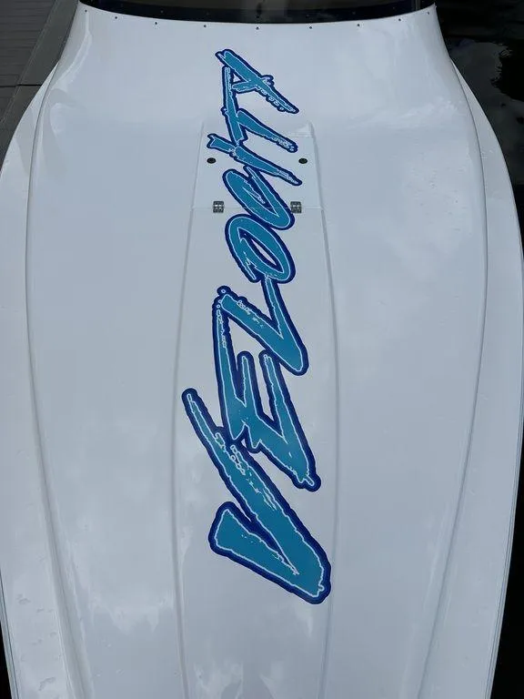 Slide: The Image of 2024 Velocity 290sc boat with bold blue logo on white hull. - 13