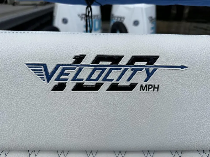 Slide: The Image of 2024 Velocity 290sc boat logo, 100 MPH speed, white upholstery. - 14