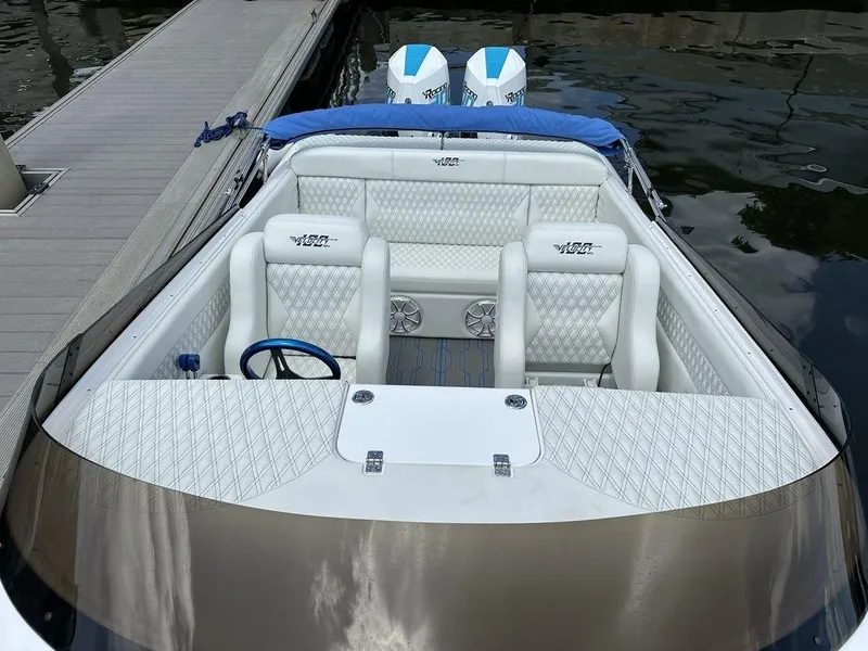 Slide: The Image of 2024 Velocity 290sc speedboat with white leather interior and twin outboard engines. - 18