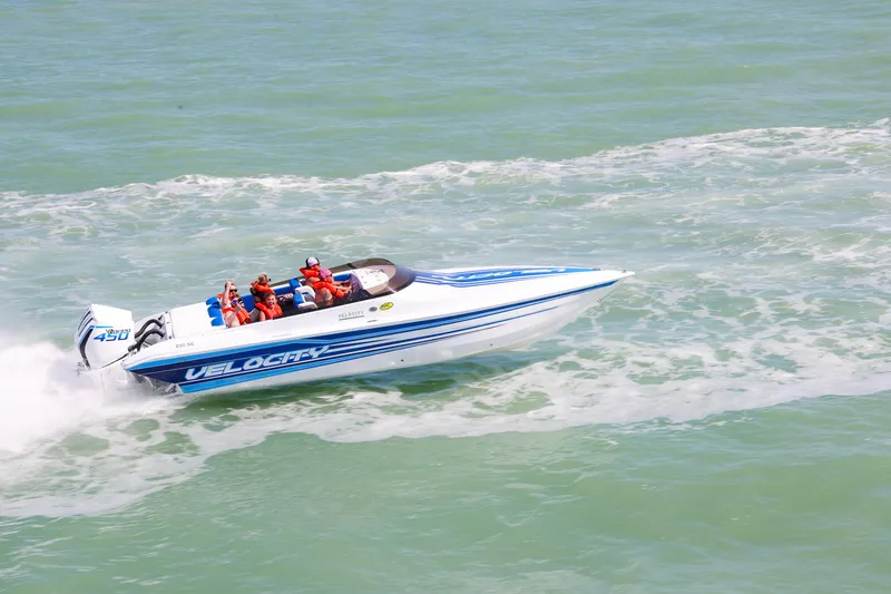 Slide: The Image of 2026 Velocity 290 SC speedboat cruising on open water with passengers in life jackets. - 2