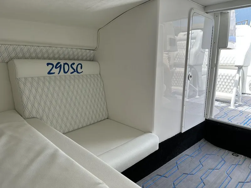 Slide: The Image of 2024 Velocity 290SC boat interior with white seating and blue accents. - 20