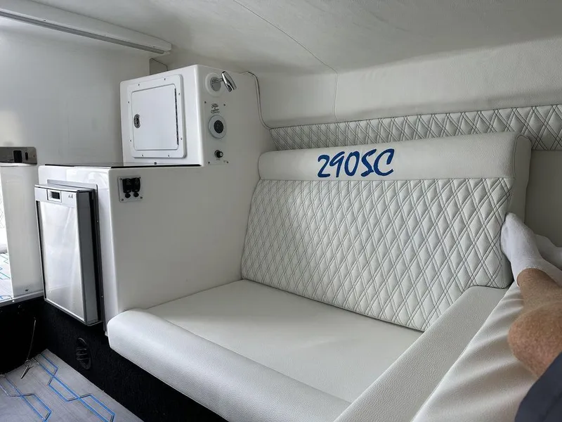 Slide: The Image of 2024 Velocity 290SC boat interior with white seating and compact appliances. - 21