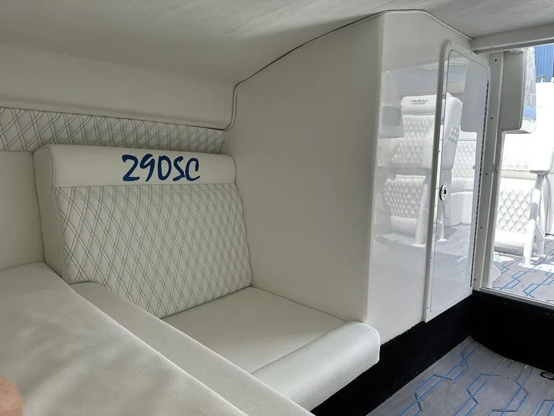 Slide: The Image of 2024 Velocity 290SC boat interior with white seating and diamond stitching. - 22