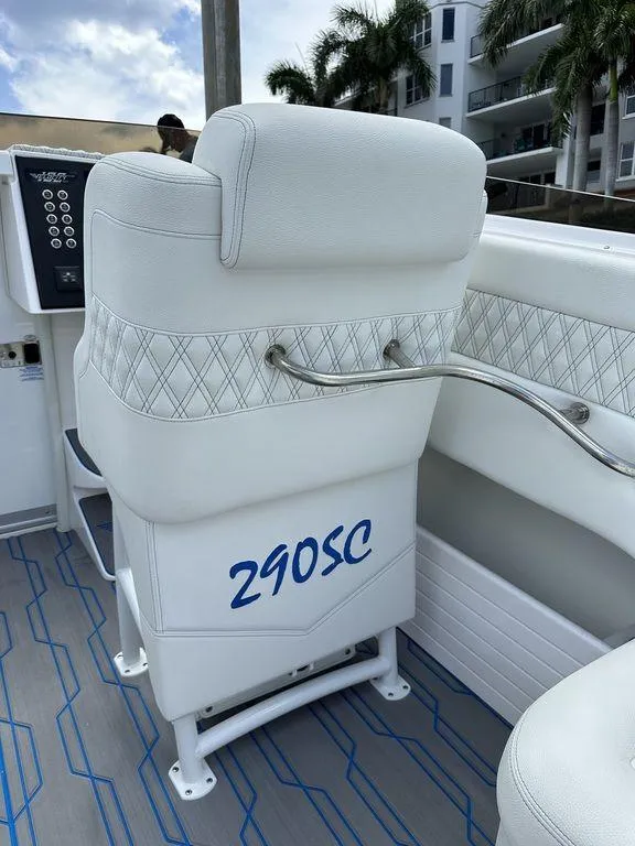 Slide: The Image of Velocity 290SC 2024 boat interior with white seating and blue accents. - 28