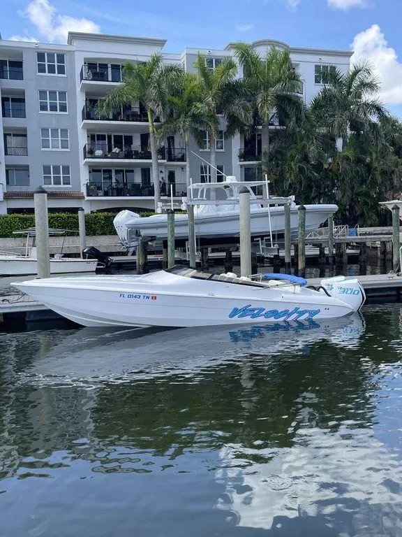 Slide: The Image of 2024 Velocity 290sc speedboat docked near waterfront apartments. - 34