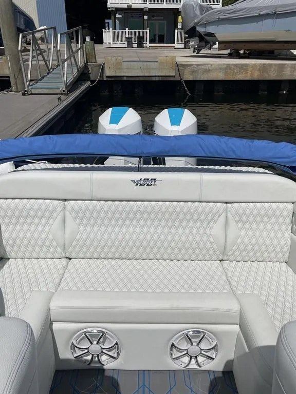 Slide: The Image of 2024 Velocity 290sc boat interior with white quilted seats and dual outboard motors. - 37