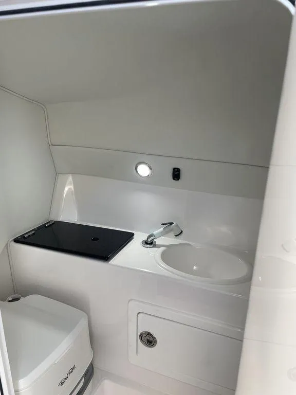Slide: The Image of 2024 Velocity 290sc boat interior bathroom with sink and toilet. - 42