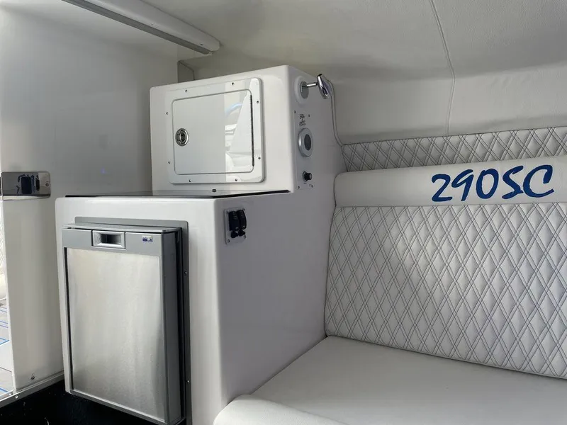 Slide: The Image of Interior of 2024 Velocity 290SC boat with mini fridge and cushioned seating. - 43